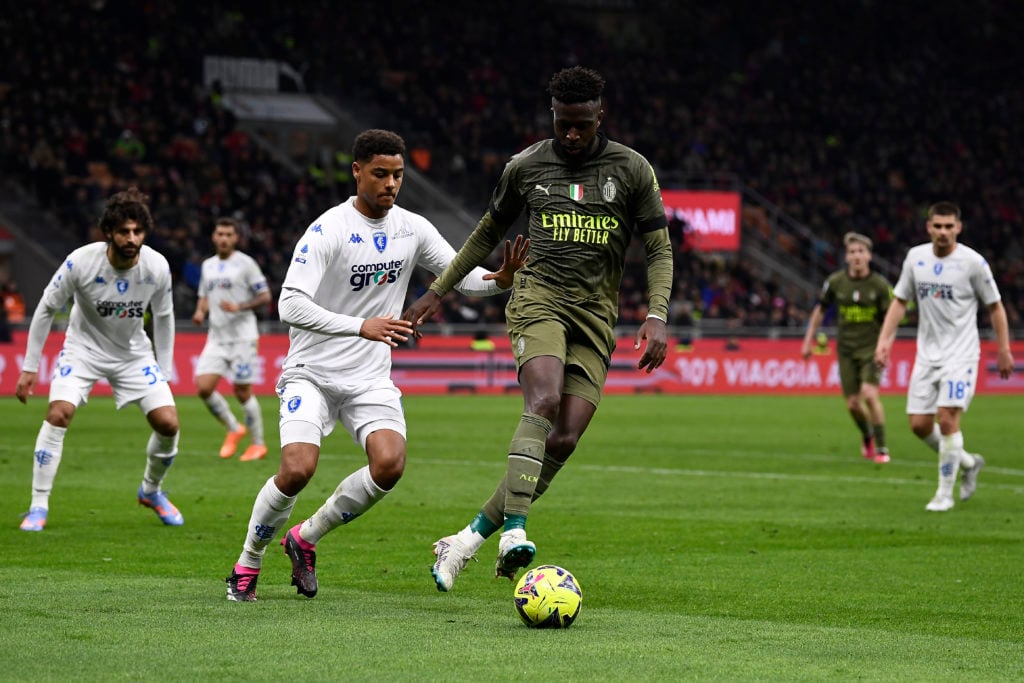 Divock Origi (R) of AC Milan competes for the ball with Koni