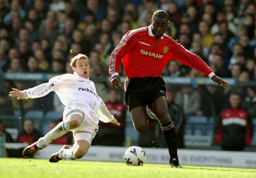 Lee Bowyer of Leeds United challenges Andy Cole of Manchester United