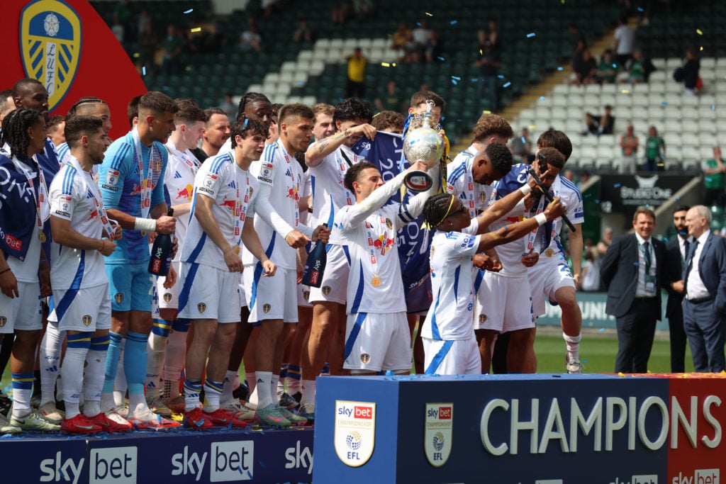 Ethan Ampadu lifts the Championship trophy as Leeds United players celebrate.