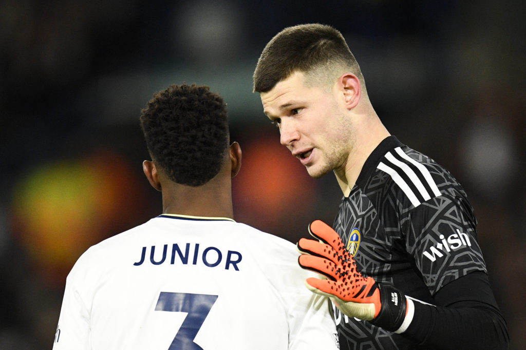 Illan Meslier talks to Junior Firpo during a Leeds United Premier League match.