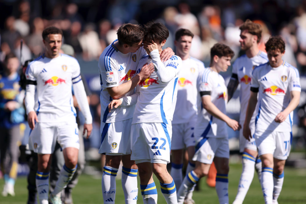 Max Wober consoles Ao Tanaka after a Leeds United match.