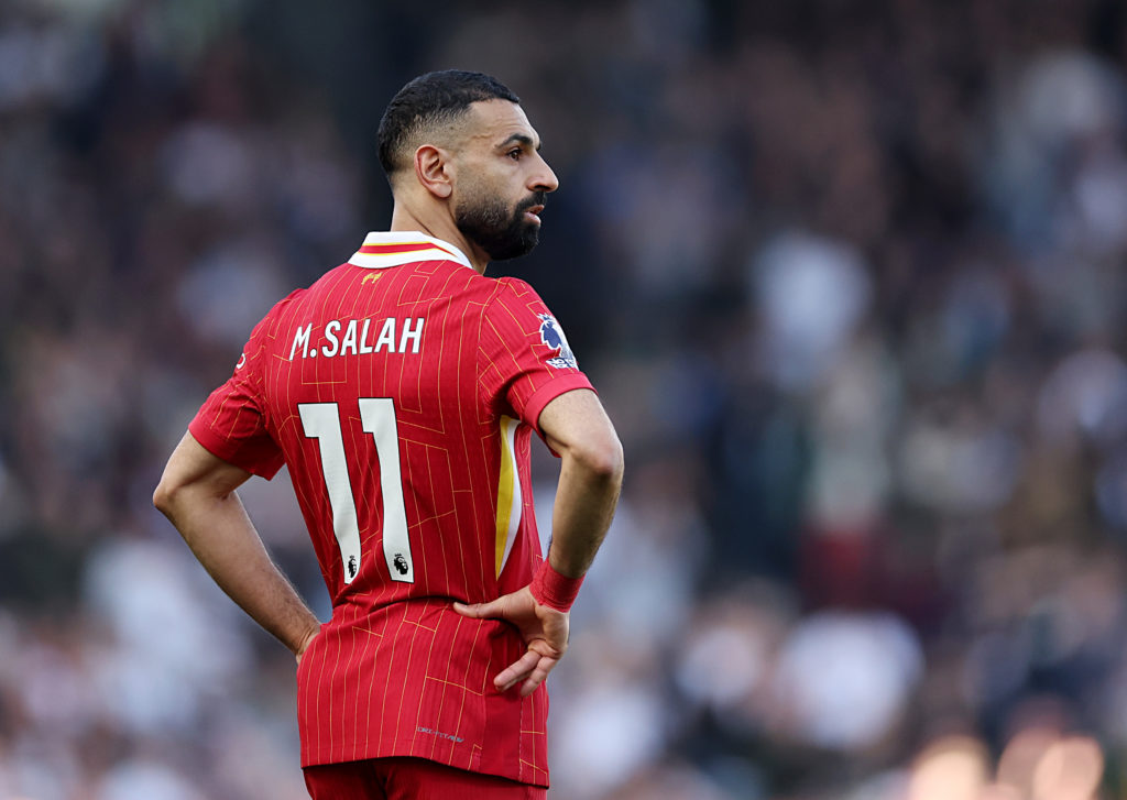Liverpool star Mohamed Salah puts his hands on his hips.