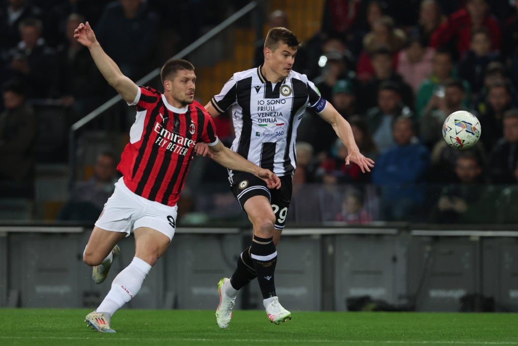 Jaka Bijol wins the ball for Udinese against Milan.