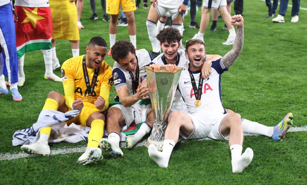 Archie Gray celebrates with the Europa League trophy and Brandon Austin, Brennan Johnson and James Maddison.