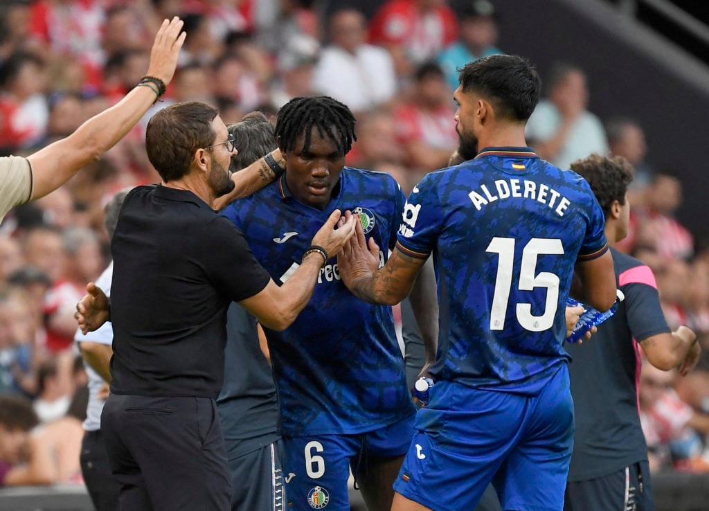 Christantus Uche gets someadvice from his Getafe manager.