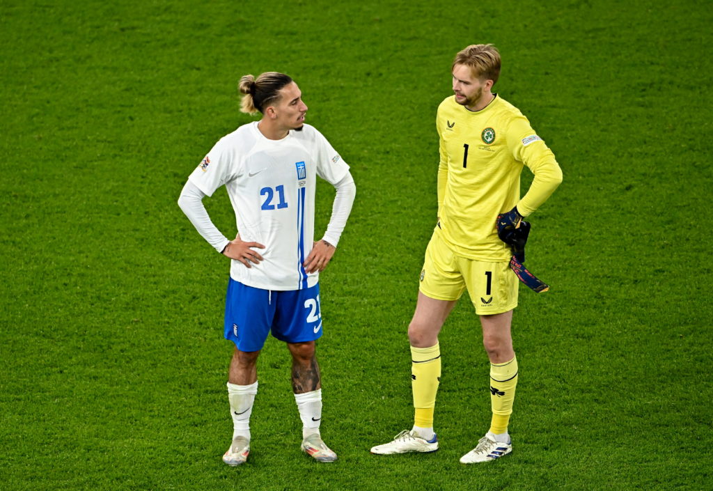 Konstantinos Tsimikas and Caoimhin Kelleher chat on the pitch.