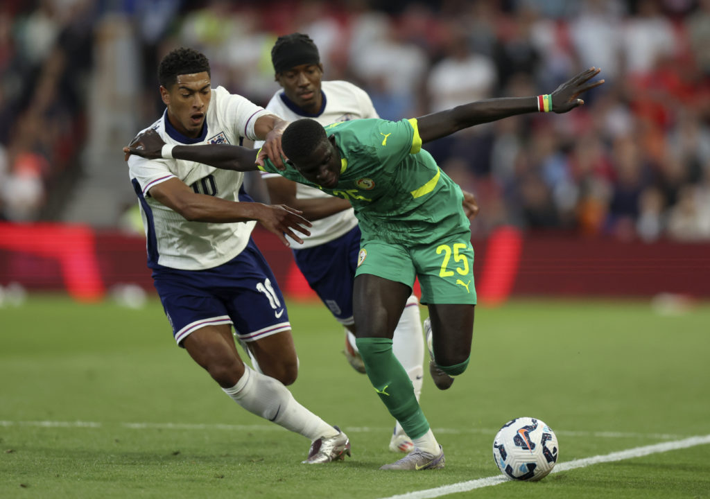 El Hadji Malick Diouf goes past Jude Bellingham.