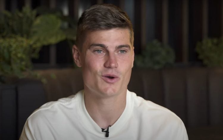 Close up shot of Jaka Bijol as he speaks in an interview with Leeds United. Credit: Leeds United FC on YouTube: Timestamp: 0:46.
