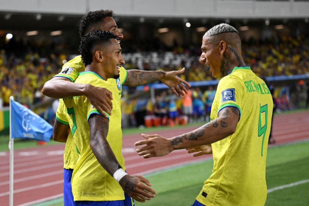 Richarlison celebrates with Raphinha for Brazil.