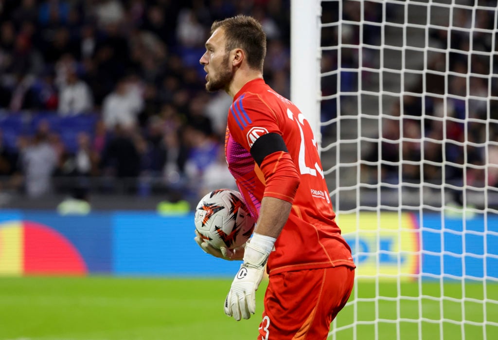 Lyon goalkeeper Lucas Perri holds the ball.