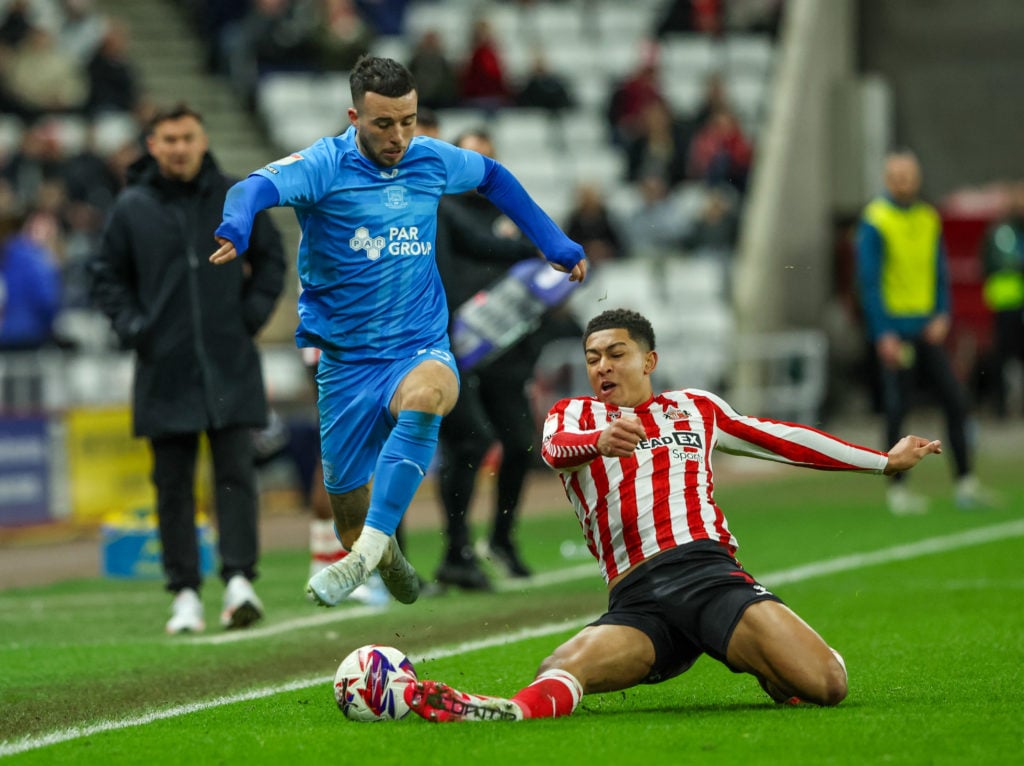 Preston's Sam Greenwood challenges Sunderland's Jobe Bellingham.