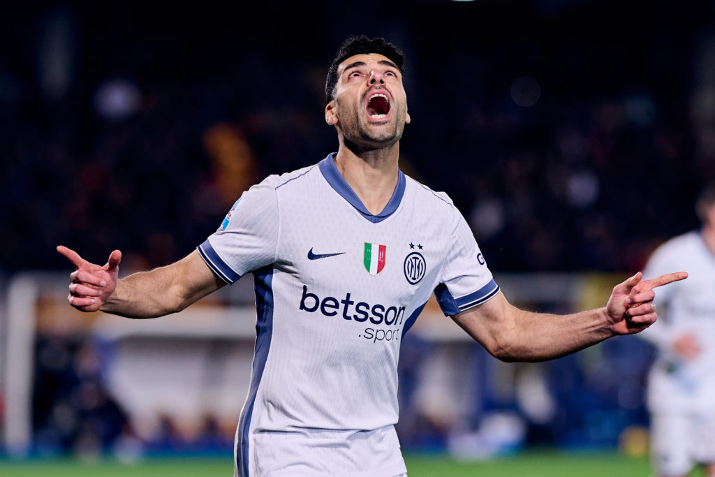 Mehdi Taremi points and looks to the sky after scoring a goal for Inter.