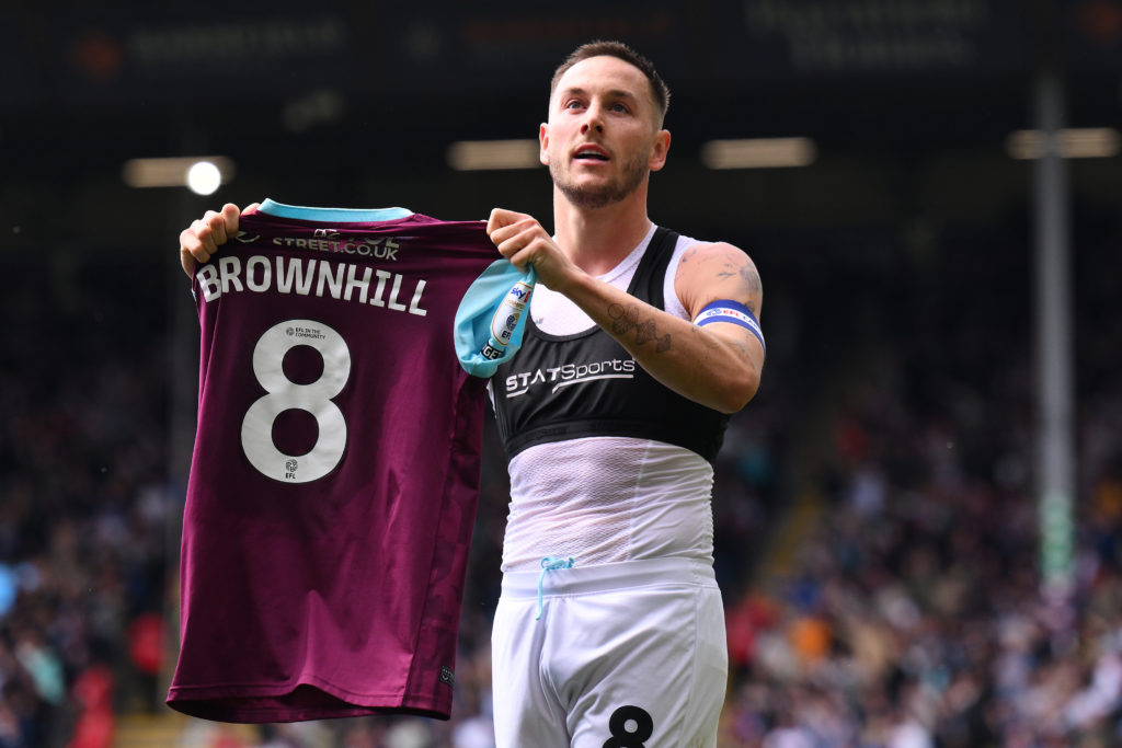 Josh Brownhill holds up Burnley shirt after scoring.