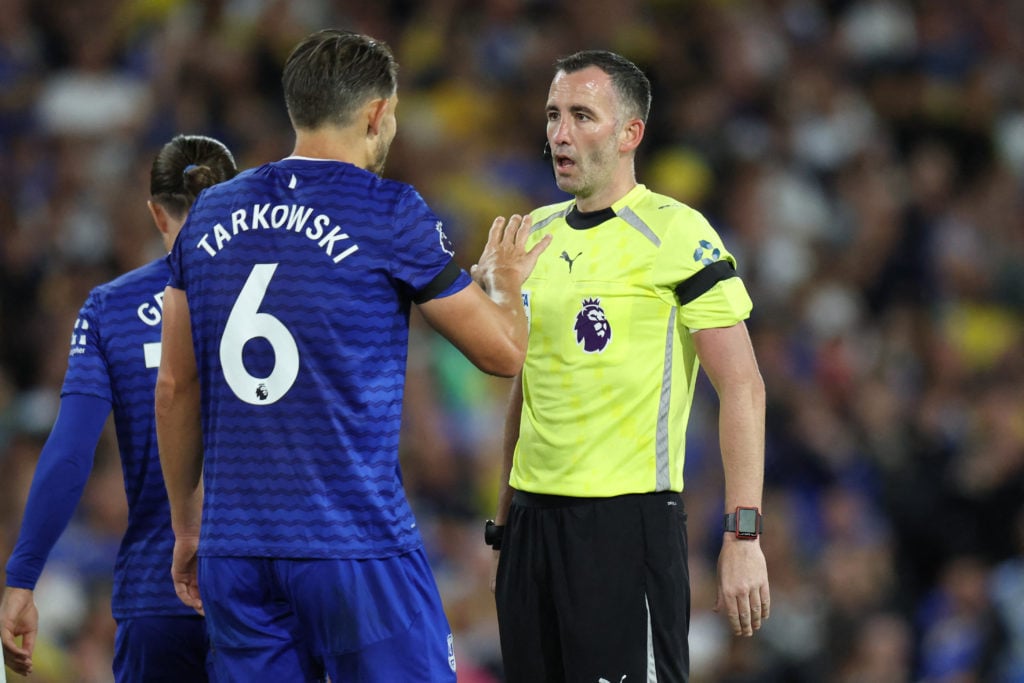 James Tarkowski argues with referee Chris Kavanagh during Leeds United vs Everton