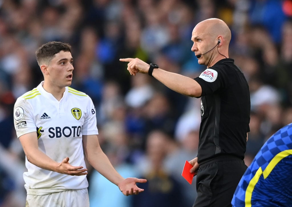 Dan James is shown a red card by Anthony Taylor during Leeds United v Chelsea