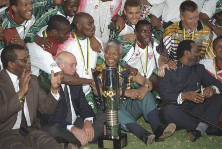 3 Feb 1996:  President Nelson Mandela celebrates with the South African players after their victory in the African Nations Cup Final against Tunisi...