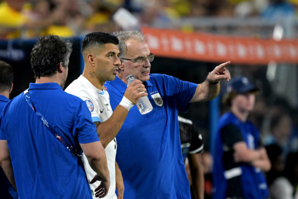 Luis Suarez in conversation with Uruguay manager Marcelo Bielsa