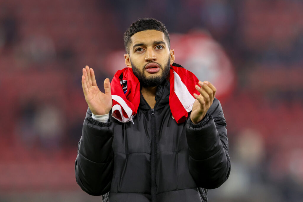 Ismael Saibari wears a shirt round his neck and applauds.