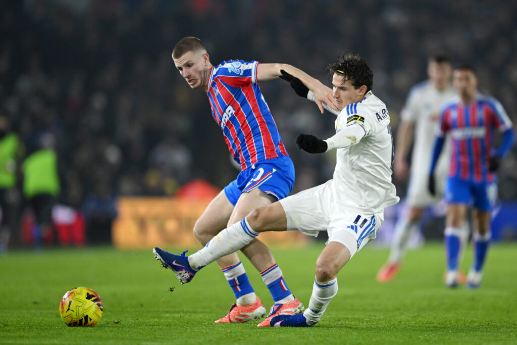 Brenden Aaronson challenges Adam Wharton during Leeds United's clash with Crystal Palace